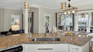 A kitchen with granite countertops, a stainless steel sink, and pendant lighting. - Short Stays! Family Beach Spot! Dog Friendly! Steps to the BEACH! (Isle of Palms)