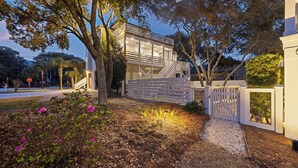 A modern house with a white exterior, a visible staircase, and a gated entrance. - Short Stays! Family Beach Spot! Dog Friendly! Steps to the BEACH! (Isle of Palms)