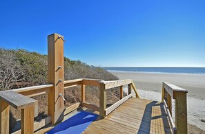 Walk along the boardwalk to the pristine beach.