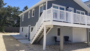 A two-story house with a covered front porch, a staircase leading to the upper floor, and a garage.