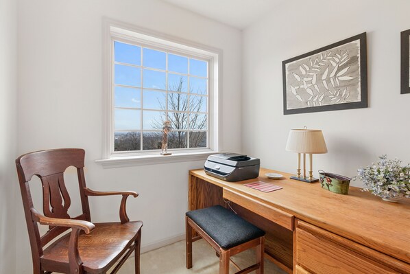 A wooden desk with a printer, a lamp, and a vase with flowers. - In the heart of Amish Paradise with GREAT view of Lancaster County! (Ronks)
