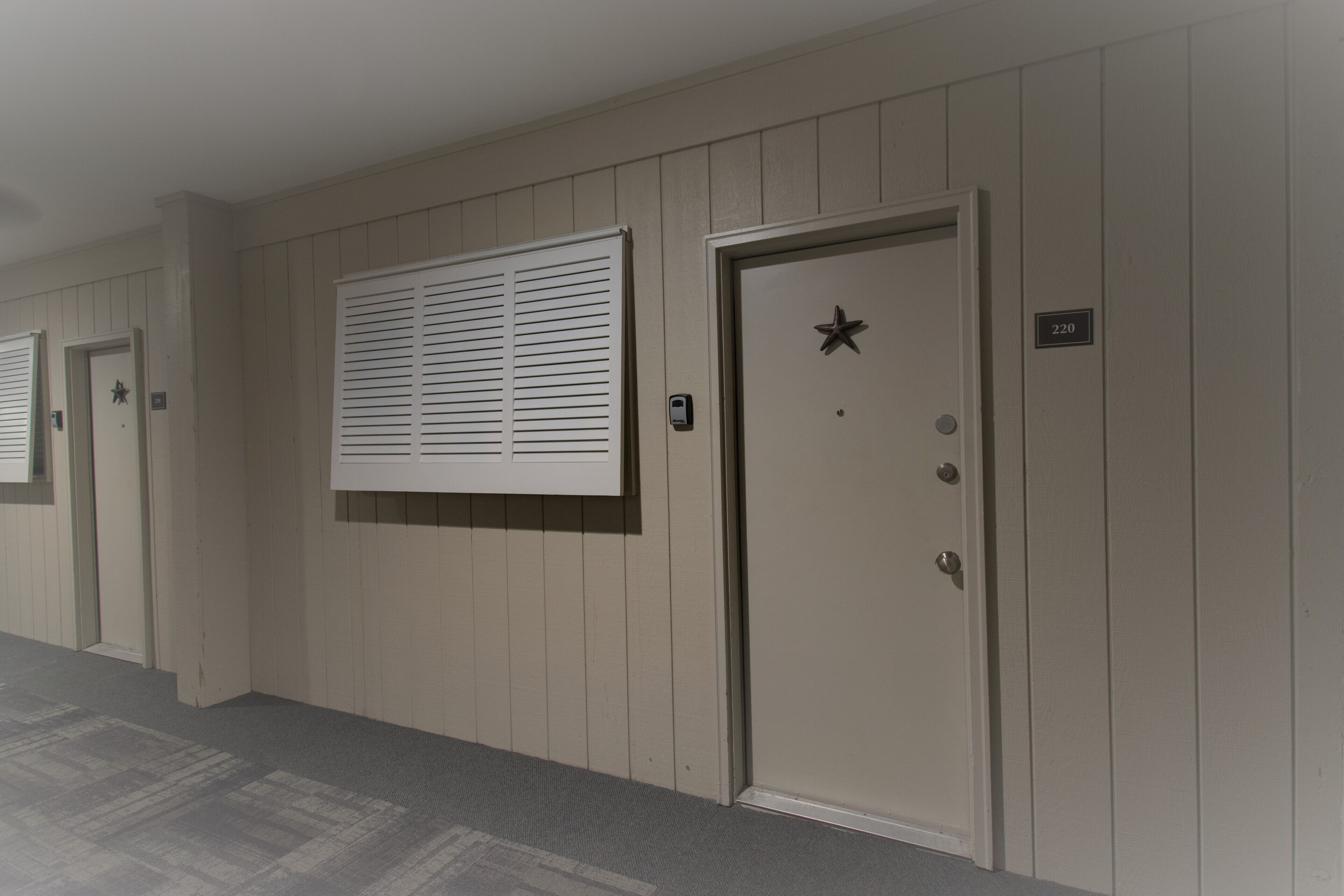 A hallway with doors, each marked with a number.