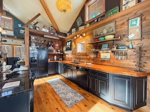 A kitchen with wooden cabinets, a black refrigerator, and a wooden countertop. - Story Land, Jackson Village, Ski-in Ski out Black Mtn, Private Views Cozy Charm (Jackson)