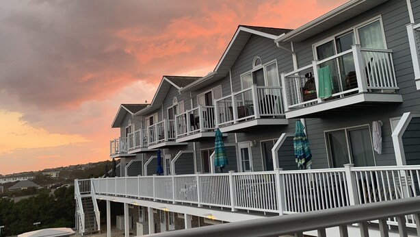 A multi-story hotel with balconies and outdoor seating areas. - PERFECT, BEAUTIFULLY NEWLY DESIGNED 1,000 FT. MONTAUK OCEANFRT 3-LEVEL TOWNHOUSE (Montauk)