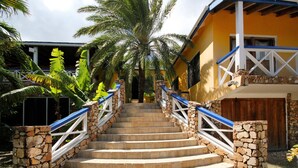 A set of stone steps leading to a house with a blue railing, surrounded by palm trees. - The Carib House, Turtle Bay 5 room villa, pool, views, beach, English Harbour no (St Paul)