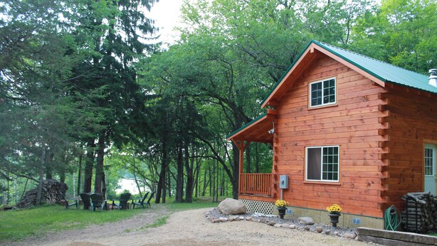 A rustic log cabin with a porch, surrounded by a forest. - Cozy Authentic Amish Cabin, 5 Acres Of Privacy, 4 Wheel Trail, Snowmobile Trail (Lampson)