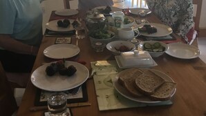 A dining table set with plates, bowls, and a bottle of Heineken beer. - Tullig Rock a Beautiful Country Home; Also available, Stone Cottage (Leap)
