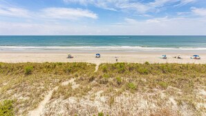 A beach with sand dunes in the foreground and a clear sky. - Spectacular 3 BR/3BA Oceanfront Condo -2 Large Balconies- Best Views-Aug wks ! (North Myrtle Beach)