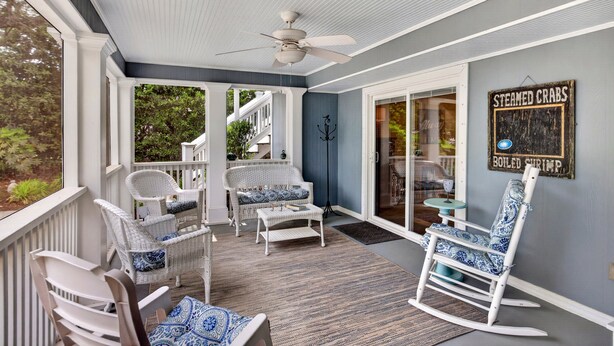 A covered porch with wicker furniture, a ceiling fan, and a sign reading 'Steamed Crabs.' - Private Pool, 2 Blocks to Beach--Perfect Family Getaway! (Isle of Palms)
