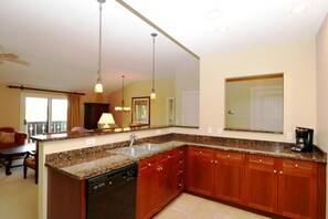 Enjoy cooking in this well-equipped kitchen with a dishwasher, large island, and coffee maker.
