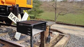 A railway crossing with a metal barrier and a 'RAIL' sign.