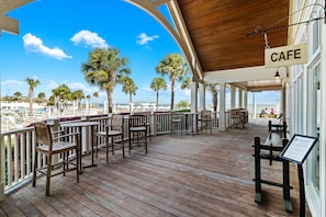 Enjoy the ocean view from our deck, surrounded by palm trees and comfortable seating areas.