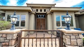 A house with a stone entrance, a wooden door, and two street lamps. - 5 Bedrooms with Heated Private Pool, Last minute rates are posted! (Saint George/Washington)