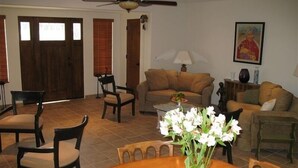 A spacious living room with a dining table, chairs, a sofa, and a ceiling fan. - 4 Bedroom plus den/office 3 Bath Private House W/Pool & Hot Tub in Palm Spring (Palm Springs)