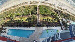 A resort with a pool area, a boardwalk, and a beach. - Oceanfront Gem Clean 1080sf New Furniture, Beds, Carpet Free WiFi Cable Gym Park (Myrtle Beach)