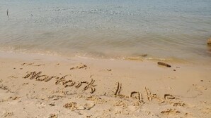 A beach with sand and water, with the words "Marshland Lake" written in the sand. - Clean, Family/Pet Friendly Lake View, 2-Bdrm Cabin Near Several Marinas/launches (Gamaliel)
