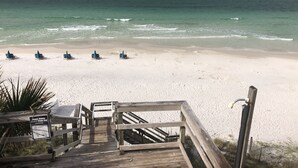 A wooden boardwalk leading to beach chairs on a sandy beach with a view of the ocean. - GULF FRONT - GREAT VIEWS - Direct Walk Out - Only Steps to Private Beach (Inlet Beach)