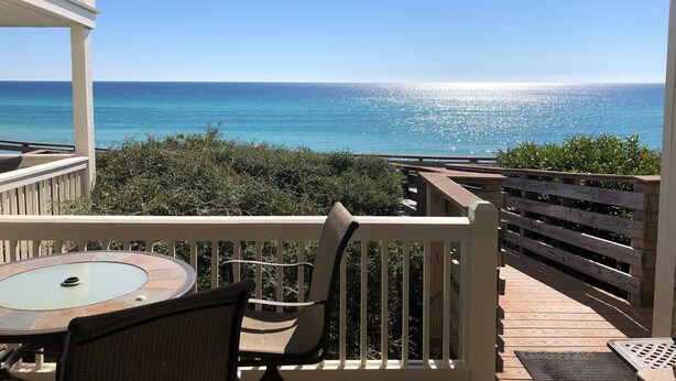 A covered outdoor area with a table and chairs, overlooking a clear blue ocean. - GULF FRONT - GREAT VIEWS - Direct Walk Out - Only Steps to Private Beach (Inlet Beach)