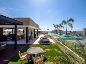A resort with a pool, outdoor seating, and a view of the ocean. - BRAND NEW, LUX ONE BEDROOM IN OLD TOWN, 3 BLOCKS FROM THE OCEAN, OLD TOWN (Puerto Vallarta)