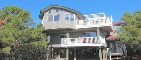 A two-story house with a balcony on the upper level.