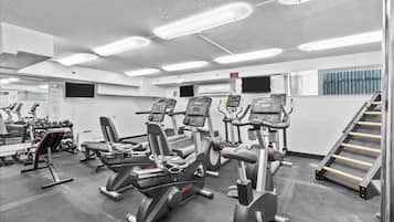 A gym with various exercise equipment, including treadmills and weight machines.