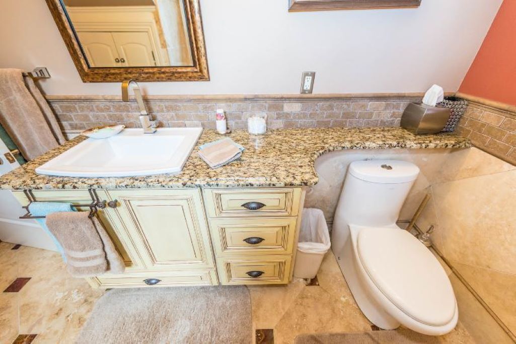 A bathroom with a sink, toilet, and vanity.