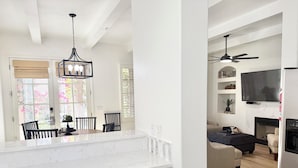 A modern kitchen with white cabinetry, a marble countertop, and pendant lighting. - Winter dates going fast! Beautifully renovated 3bd/3bth poolside, mountain views (La Quinta)