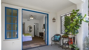 A room with a bed, a chair, a table, and a potted plant. - Winter dates going fast! Beautifully renovated 3bd/3bth poolside, mountain views (La Quinta)