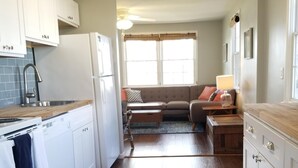 A modern kitchen with white cabinets, a built-in oven, and a ceiling fan. - Beach block! 4 Bed 2 Bath - 1st floor duplex! (Brigantine)