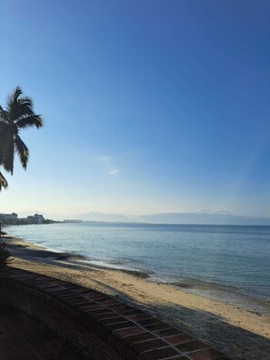 Na praia, espreguiçadeiras, toalhas de praia 