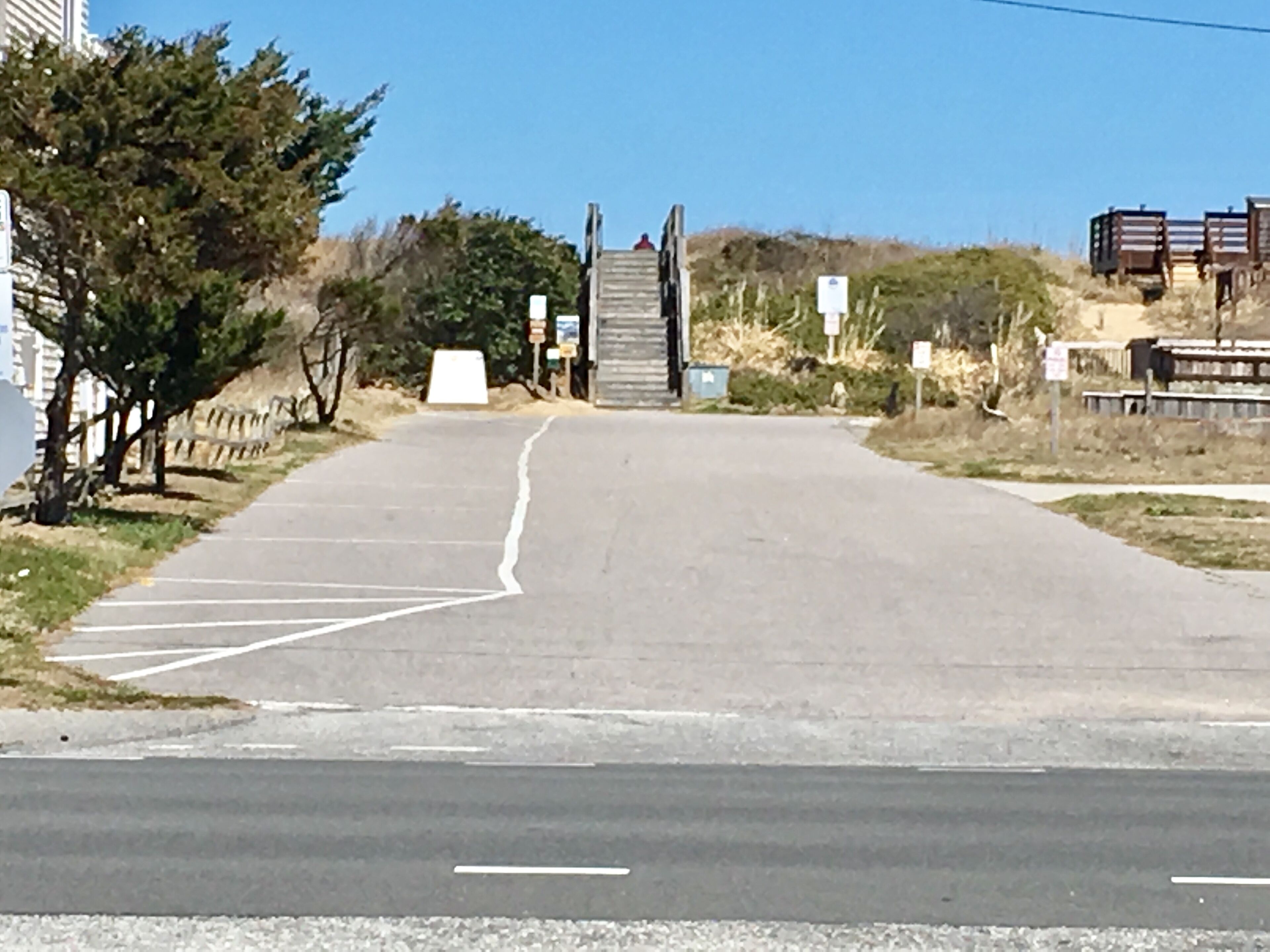 A road leading to a building with a gated entrance.