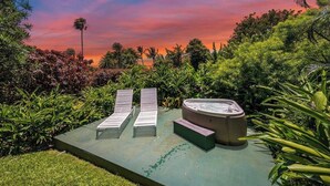 A hot tub, two lounge chairs, and lush greenery. - Haleakala Cottage - private hot tub, pool access (Haiku)