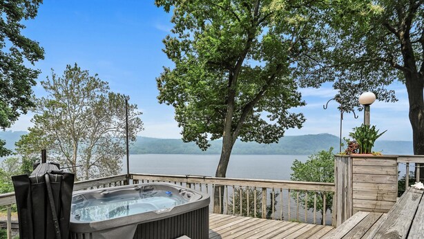 A hot tub on a wooden deck with a view of a lake and mountains. - LAKE HOUSE SOUTH
Waterfront Retreat with DOCKAGE on Susquehanna River & HOT TUB (Pequea)