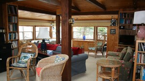 A cozy living room with wicker furniture, a blue sofa, and a bookshelf filled with books. - Experience Peace And Tranquility At Charming Cottage In Small Fishing Community. (Trinity T.B.)