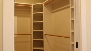A walk-in closet with wooden flooring and white shelving units. - Allegra Villa Alla Spiaggia  - See & Hear Ocean - Luxurious (Santa Cruz)