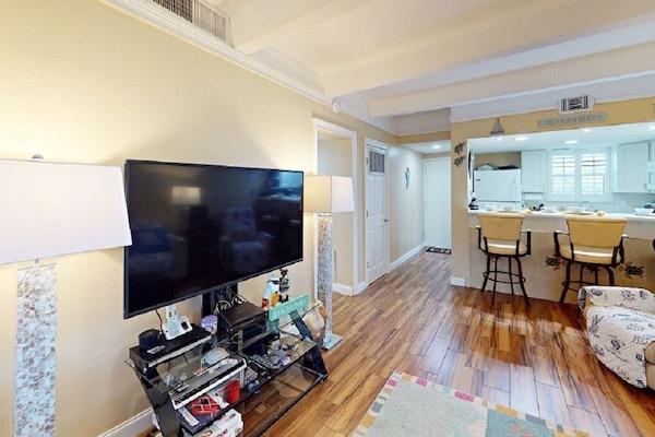 Living room looking back at the kitchen and entry way door.