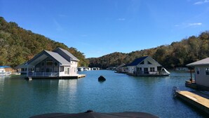 A lakeside property with floating houses connected by walkways.
