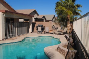 A backyard with a swimming pool, a barbecue grill, and a palm tree. - 3BR Home with Heated Private Pool, Golf, & Mountain Views (Avondale)