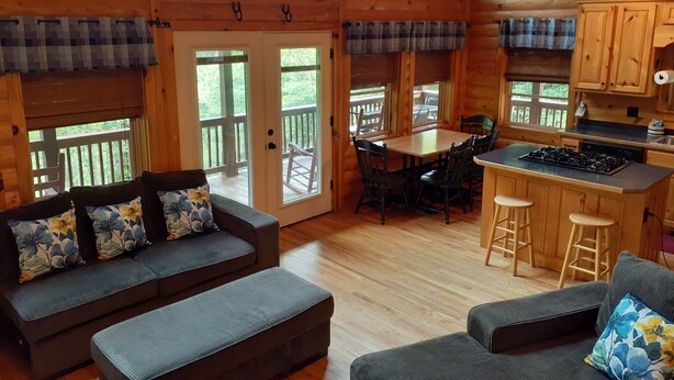 A cozy cabin interior with a dining area, kitchen, and seating area. - Private Mountain Hideaway (Andrews)