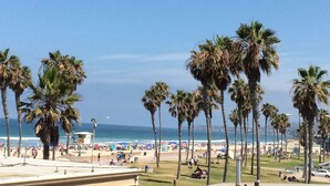 A beach with palm trees, a sandy shore, and a clear blue sky. - Amazing Proximity to the Beach and Bay with Direct Ocean Views! (San Diego)