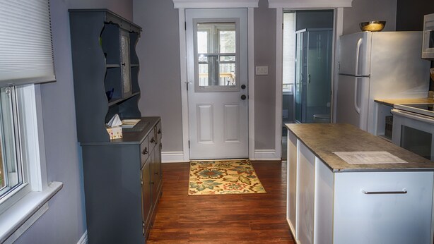 A compact kitchen with a refrigerator, a microwave, and a wooden countertop. - Entire house 10 minute walk to The Falls and all Attractions! No Car Needed (Niagara Falls)