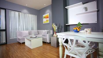 A modern living room with a sofa, coffee table, and dining table.