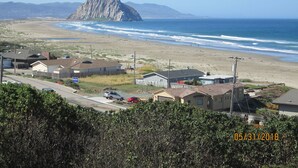 A coastal town with houses, a beach, and a prominent rocky hill in the distance. - Suite 16th - Old time charm, Free WiFi, Cable, Downtown (Paso Robles)