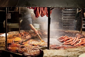 Guests can enjoy a meal prepared in this open-air cooking area featuring a grill.