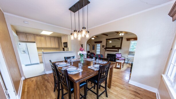 A spacious dining area with a wooden table set for six, surrounded by dark wooden chairs. - Great Location in Cheyenne Cañyon, 3Bd, 1.5Bath, Private fenced yard and deck! (Colorado Springs)