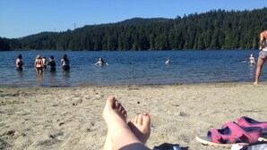 A beach with people swimming and relaxing.