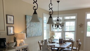 A kitchen with a central island, pendant lighting, and a large window providing natural light. - Great Location - Close to Beach, Boardwalk, Asbury Shops and Cafes! (Ocean City)