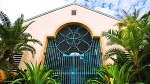 A building with a large arched window and a blue gate.
