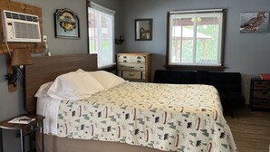 A bedroom with a bed, a dresser, a desk, and a ceiling fan. - Clean, family/pet friendly AR Ozark Mountain/Norfork Lake Front Cabin (Gamaliel)