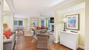 A spacious living room with a sofa, chairs, a coffee table, and a white dresser. - The FAMILY Spot in Wild Dunes - Walking Distance to Beach - Pool Access (Isle Of Palms)